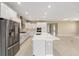 Open concept kitchen with stainless appliances, white cabinets, and central island at 10026 Sw 85Th Place Rd, Ocala, FL 34481