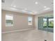 Spacious living room featuring recessed lighting, tile flooring, neutral walls, and sliding doors to the outside at 10026 Sw 85Th Place Rd, Ocala, FL 34481