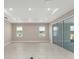 Spacious living room features a tray ceiling, recessed lighting, and sliding glass doors at 10026 Sw 85Th Place Rd, Ocala, FL 34481