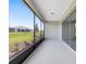 A covered patio with sliding glass doors and a screen overlooks the backyard area at 10026 Sw 85Th Place Rd, Ocala, FL 34481