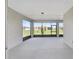A covered patio with a screen offers an outdoor space to enjoy the backyard view at 10026 Sw 85Th Place Rd, Ocala, FL 34481