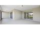 This covered patio has a neutral color scheme, sliding glass doors, and ceiling lights at 10026 Sw 85Th Place Rd, Ocala, FL 34481