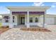 Covered front porch featuring decorative columns and a patterned brick walkway leading to the front door at 10026 Sw 85Th Place Rd, Ocala, FL 34481