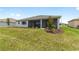 Large, well-manicured backyard with a screened-in lanai and fresh landscaping at 10045 Sw 82Nd Place Rd, Ocala, FL 34481