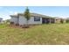 Large backyard with a screened-in lanai and ample green space at 10045 Sw 82Nd Place Rd, Ocala, FL 34481