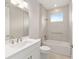 Bathroom with a white vanity, tub, and tiled shower at 10045 Sw 82Nd Place Rd, Ocala, FL 34481