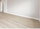 Unfurnished bedroom with light wood-look flooring, neutral walls and white trim at 10045 Sw 82Nd Place Rd, Ocala, FL 34481