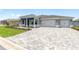 Beautiful home with a three-car garage and a spacious paver driveway at 10045 Sw 82Nd Place Rd, Ocala, FL 34481