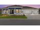 Charming home featuring a three-car garage and stylish blue accents on the front facade at 10045 Sw 82Nd Place Rd, Ocala, FL 34481