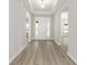 Bright foyer featuring wood-look flooring, a white front door, and neutral paint at 10045 Sw 82Nd Place Rd, Ocala, FL 34481