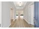 Bright foyer featuring wood-look flooring, tray ceiling and views into the open living area at 10045 Sw 82Nd Place Rd, Ocala, FL 34481