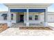 Inviting home with an entry featuring a stylish blue door and decorative trim at 10045 Sw 82Nd Place Rd, Ocala, FL 34481