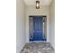 Close-up of the home's front door with sidelights and a stone pathway leading up to the entrance at 10045 Sw 82Nd Place Rd, Ocala, FL 34481