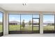 View from the screened lanai overlooking the lush green backyard and neighboring homes at 10045 Sw 82Nd Place Rd, Ocala, FL 34481
