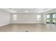 Large living room featuring wood-look floors, neutral paint, and sliding glass doors at 10045 Sw 82Nd Place Rd, Ocala, FL 34481