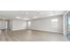 Open-concept living room with wood-look floors and views into the entryway and kitchen at 10045 Sw 82Nd Place Rd, Ocala, FL 34481