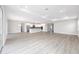Open floor plan with wood-look floors connecting the living area and kitchen at 10045 Sw 82Nd Place Rd, Ocala, FL 34481