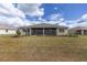 The manicured backyard is the perfect place to unwind or entertain with its screened-in lanai at 10561 Sw 98Th Pl, Ocala, FL 34481