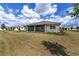 Enjoy the fresh air from your screen patio in a beautiful backyard with lush green grass at 10561 Sw 98Th Pl, Ocala, FL 34481