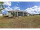 Expansive backyard features a lovely lawn and leads to the relaxing screened lanai at 10561 Sw 98Th Pl, Ocala, FL 34481