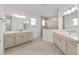 A spacious bathroom showcases dual vanities, large mirrors, and a modern glass shower at 10561 Sw 98Th Pl, Ocala, FL 34481