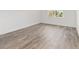Sunlit bedroom featuring modern gray wood-look flooring and white trim at 10561 Sw 98Th Pl, Ocala, FL 34481