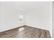 Bright bedroom with wood-look flooring and a window offering natural light at 10561 Sw 98Th Pl, Ocala, FL 34481