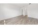 Bedroom with modern gray flooring, white trim, and neutral paint at 10561 Sw 98Th Pl, Ocala, FL 34481