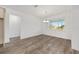 Elegant dining room with a modern chandelier and a large window offering ample natural light at 10561 Sw 98Th Pl, Ocala, FL 34481