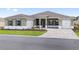 Charming single-story home with a well-manicured lawn, driveway, and a two-car garage at 10561 Sw 98Th Pl, Ocala, FL 34481