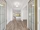 Bright foyer with wood flooring and a clear view through sliding doors to the lanai at 10561 Sw 98Th Pl, Ocala, FL 34481