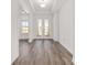 Inviting foyer with wood floors and bright, white walls at 10561 Sw 98Th Pl, Ocala, FL 34481