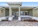 Inviting front porch with decorative columns, a brick paved entrance, and a hanging lantern at 10561 Sw 98Th Pl, Ocala, FL 34481