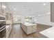Open kitchen with a large island, modern appliances, and hardwood floors leading to the living room at 10561 Sw 98Th Pl, Ocala, FL 34481
