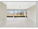 Spacious screened lanai with a white floor that provides an outdoor living space at 10561 Sw 98Th Pl, Ocala, FL 34481