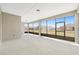 Spacious screened lanai with a white floor and views of the backyard at 10561 Sw 98Th Pl, Ocala, FL 34481