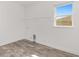 Empty laundry room with utility connections, a window, and wood-look floors at 10561 Sw 98Th Pl, Ocala, FL 34481