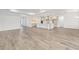 Expansive living area with light wood floors, abundant natural light, and a seamless flow into the kitchen at 10561 Sw 98Th Pl, Ocala, FL 34481