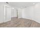Bright living room featuring wood-look floors and glass paneled double doors at 10561 Sw 98Th Pl, Ocala, FL 34481