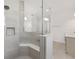 Modern shower with tile surround, built-in bench, and seamless glass partition at 10561 Sw 98Th Pl, Ocala, FL 34481