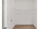 Empty walk-in closet with white walls, wire shelving, and wood-look flooring at 10561 Sw 98Th Pl, Ocala, FL 34481