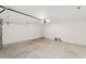 Spacious garage featuring an automatic door, overhead lighting, and durable concrete flooring at 1083 Sw Winding Hills Rd, Dunnellon, FL 34431