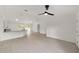 Bright, open-concept living space featuring modern light gray flooring, white walls and vaulted ceilings at 1083 Sw Winding Hills Rd, Dunnellon, FL 34431