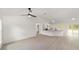 Bright living space with vaulted ceilings flowing into an open kitchen and dining area with sliding glass doors at 1083 Sw Winding Hills Rd, Dunnellon, FL 34431