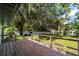 Backyard with a deck and a large, grassy yard at 11430 Se 54Th Ave, Belleview, FL 34420