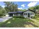 Charming single-story home featuring a well-manicured lawn, covered carport and a welcoming front entrance at 11430 Se 54Th Ave, Belleview, FL 34420