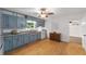 Charming kitchen with granite countertops, blue cabinets, and modern appliances at 11430 Se 54Th Ave, Belleview, FL 34420