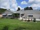 Spacious backyard featuring a well-manicured lawn, fenced patio area, and room for outdoor activities at 11470 Sw 139Th St, Dunnellon, FL 34432
