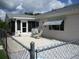 Cozy backyard patio with chain-link fence, patio chairs and grill at 11470 Sw 139Th St, Dunnellon, FL 34432