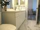 Bathroom features a white vanity, framed mirror, and tile flooring at 11470 Sw 139Th St, Dunnellon, FL 34432
